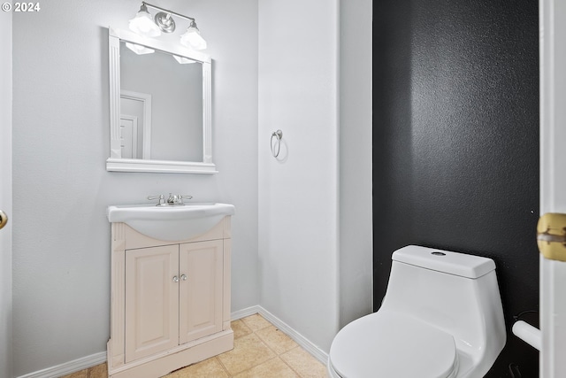 bathroom with vanity, tile patterned flooring, and toilet