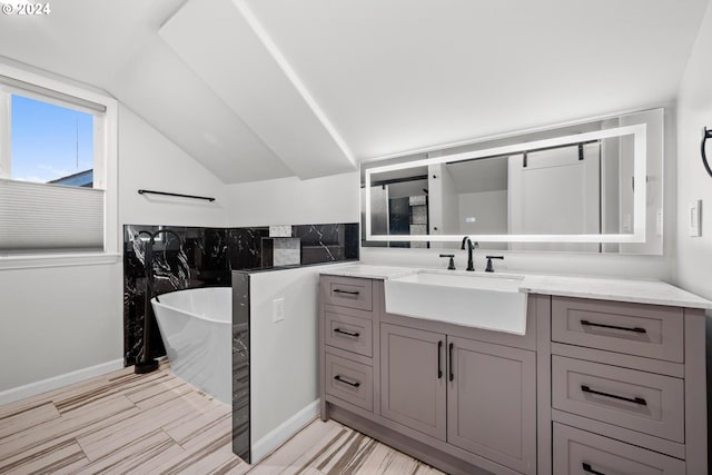 bathroom with vanity and a bath