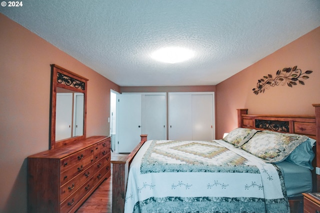 bedroom featuring a textured ceiling and hardwood / wood-style floors