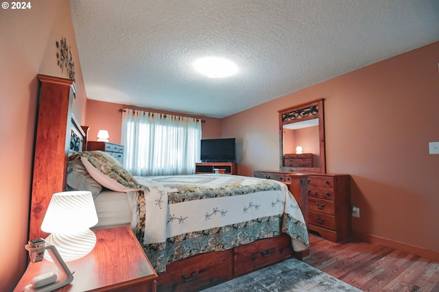 bedroom featuring a textured ceiling and hardwood / wood-style floors