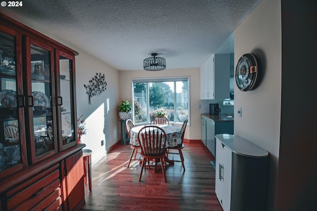 dining area featuring a textured ceiling and dark hardwood / wood-style floors