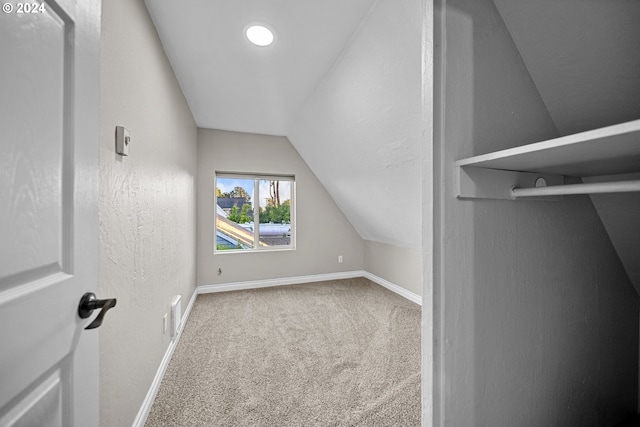 spacious closet with carpet floors and vaulted ceiling