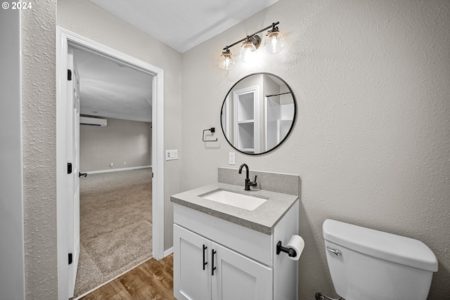 bathroom with hardwood / wood-style floors, vanity, and toilet