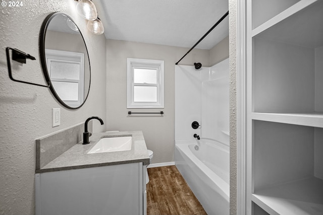 bathroom featuring shower / tub combination, wood-type flooring, and vanity