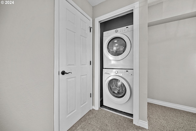 laundry room with stacked washer and dryer and carpet floors