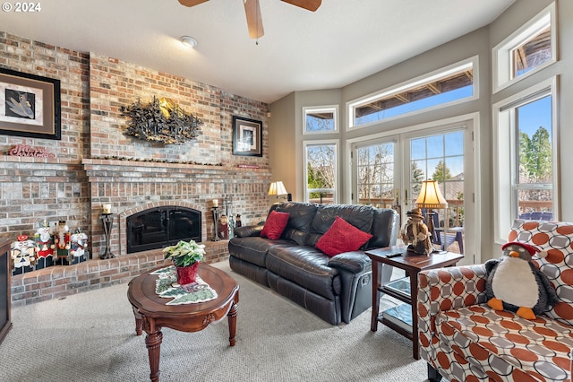 carpeted living room with a brick fireplace, ceiling fan, and brick wall