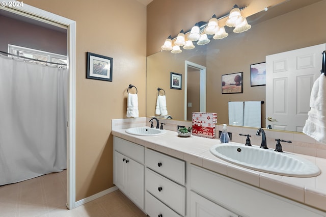 bathroom featuring tile patterned flooring and vanity