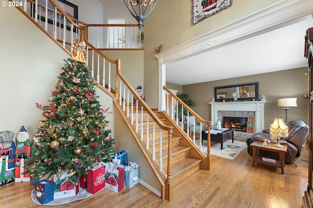 stairway featuring a fireplace and hardwood / wood-style floors