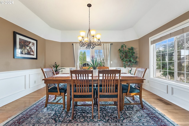 dining area featuring hardwood / wood-style floors and a notable chandelier