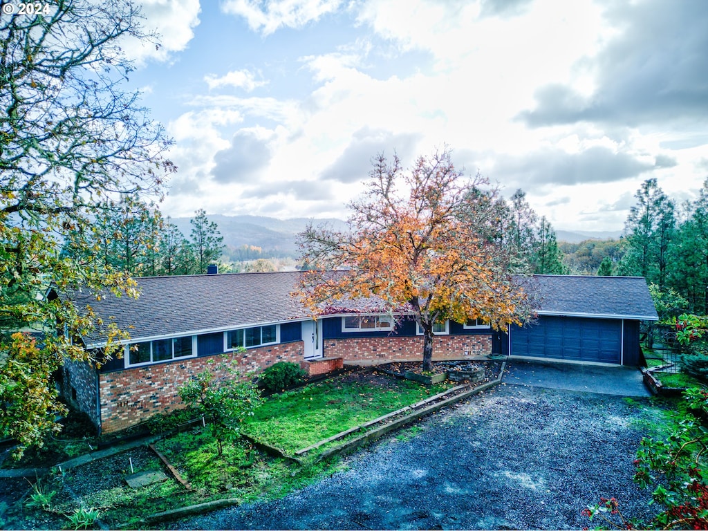 view of front of property featuring a garage and a mountain view