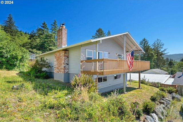 back of house with a wooden deck