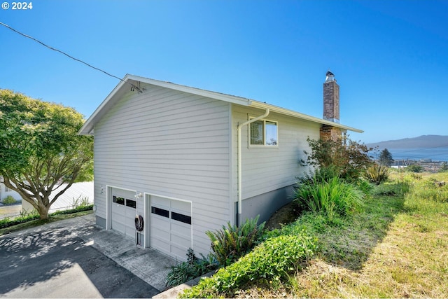 view of home's exterior featuring a garage and a mountain view