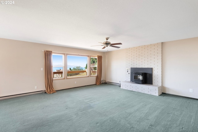 unfurnished living room with a baseboard heating unit, a wood stove, ceiling fan, and carpet flooring