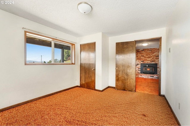 unfurnished bedroom with a closet, carpet, and a textured ceiling