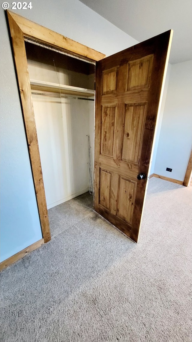 unfurnished bedroom with carpet floors and a closet