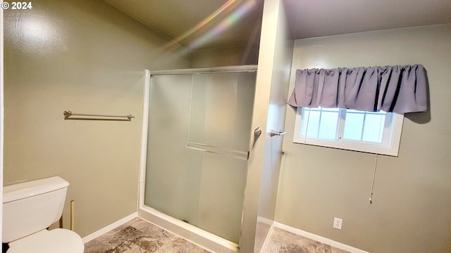 bathroom featuring toilet and walk in shower