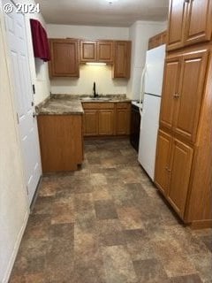 kitchen with white refrigerator and sink