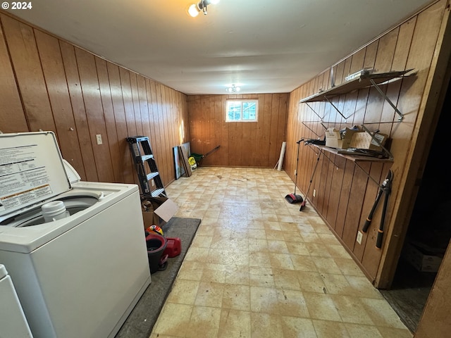 laundry room featuring washer / dryer and wood walls