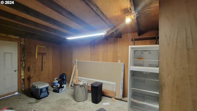 basement featuring wooden walls