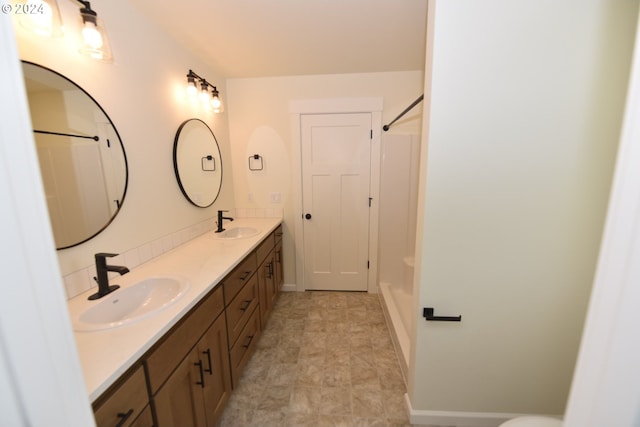 bathroom with vanity and a shower