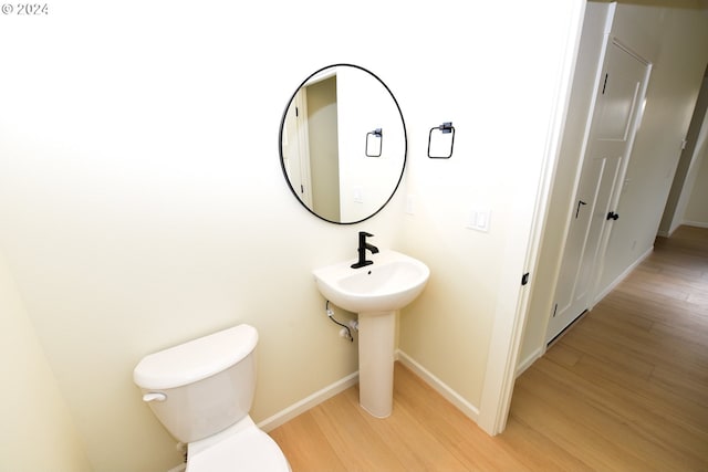 bathroom featuring toilet and hardwood / wood-style floors