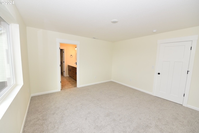 carpeted empty room with a healthy amount of sunlight