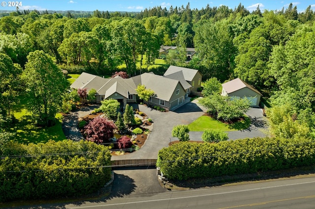 birds eye view of property with a view of trees