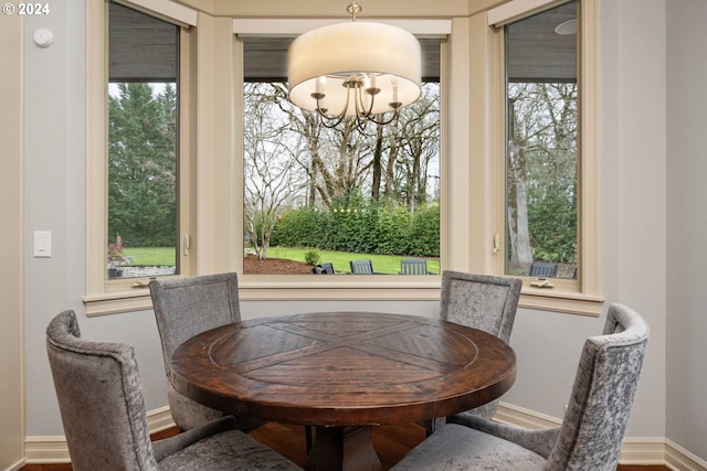 dining room featuring baseboards and a chandelier