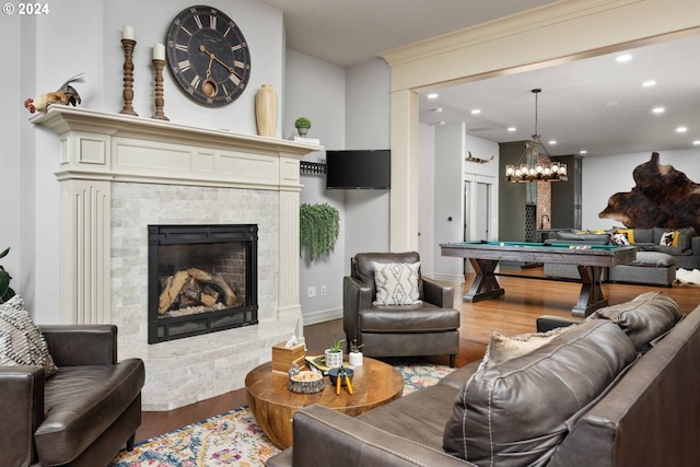 living area with billiards, wood finished floors, recessed lighting, baseboards, and a tile fireplace