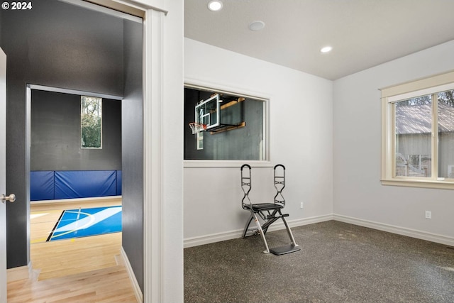 exercise room with recessed lighting, baseboards, and a wealth of natural light