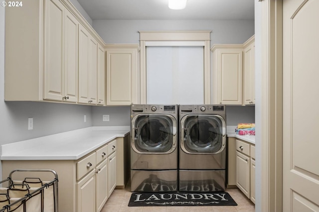 laundry area with light tile patterned floors, cabinet space, and separate washer and dryer