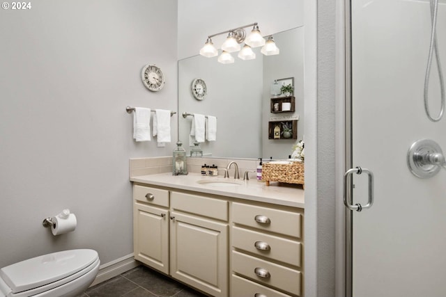 full bathroom featuring baseboards, toilet, a stall shower, tile patterned floors, and vanity