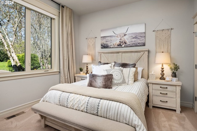 carpeted bedroom with visible vents and baseboards