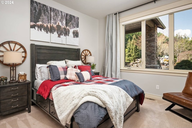 bedroom with visible vents and carpet flooring