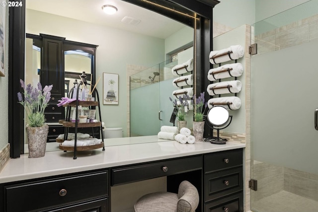 full bathroom featuring toilet, a stall shower, and vanity