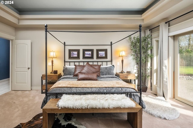 bedroom featuring access to exterior, carpet flooring, and baseboards