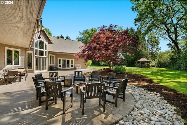 view of patio featuring a gazebo and a fire pit