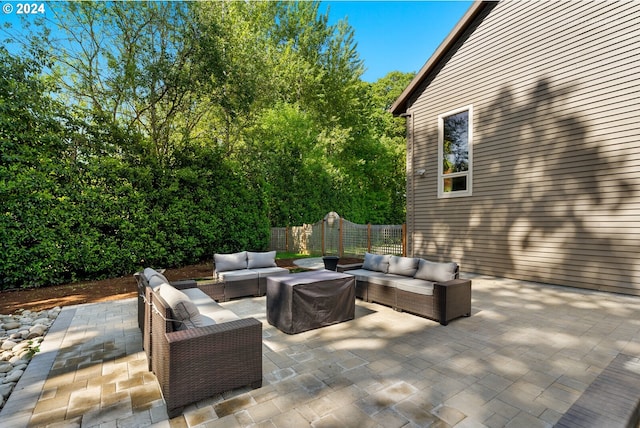 view of patio with an outdoor living space and fence