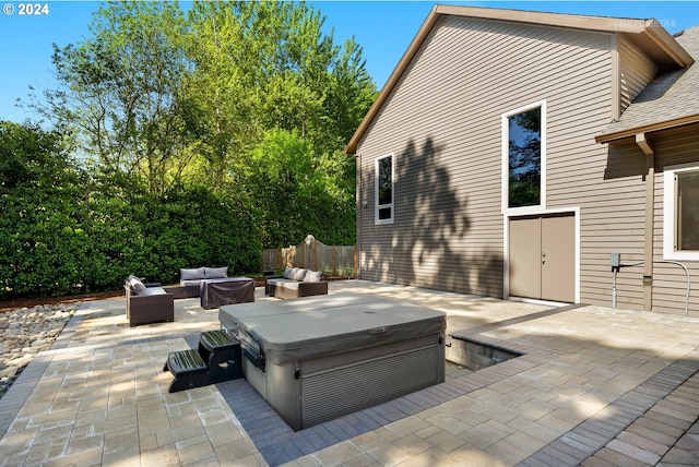 view of patio / terrace with an outdoor hangout area and a hot tub