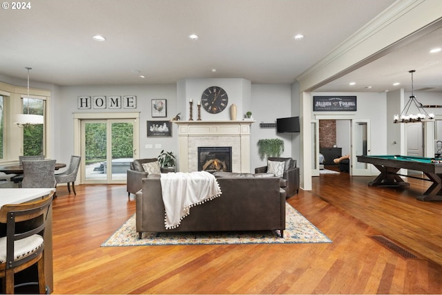 living area featuring visible vents, wood finished floors, recessed lighting, pool table, and a tile fireplace