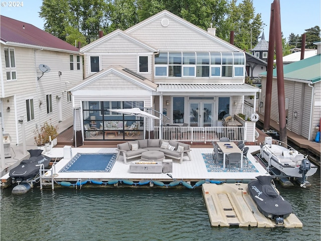 back of house featuring french doors, an outdoor hangout area, and a water view