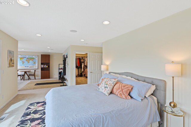 bedroom with carpet floors, a closet, and a walk in closet