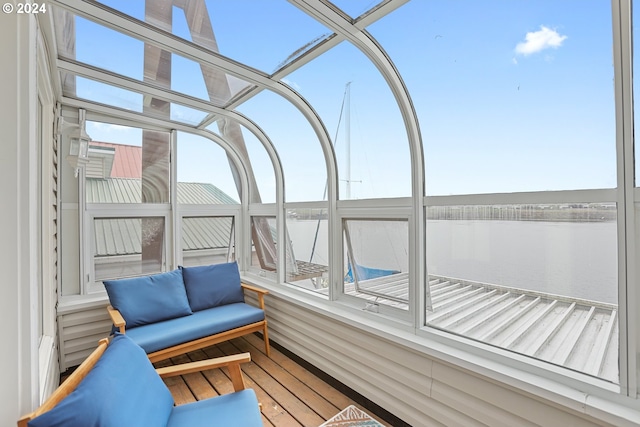 unfurnished sunroom with a water view