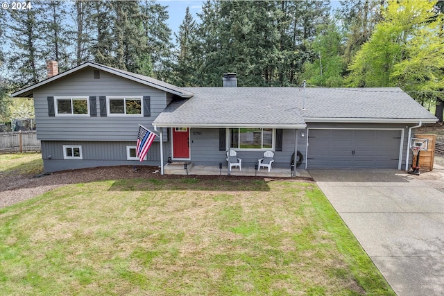 tri-level home with a garage and a front lawn