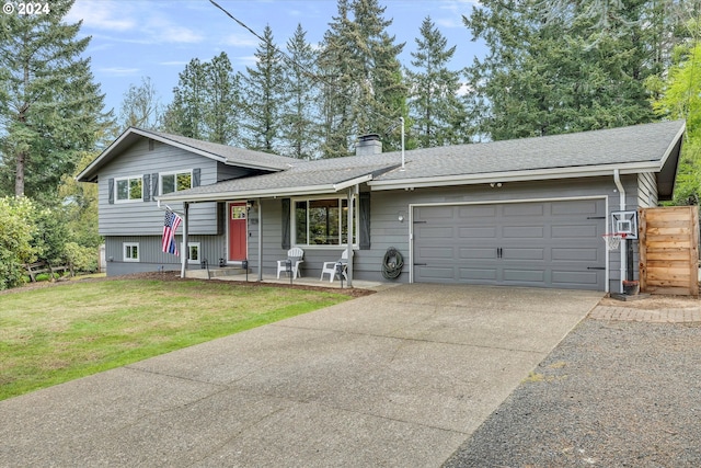 tri-level home with a front yard and a garage