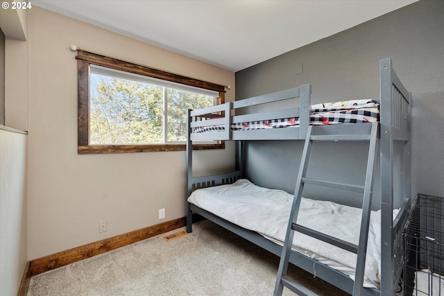 bedroom featuring light carpet