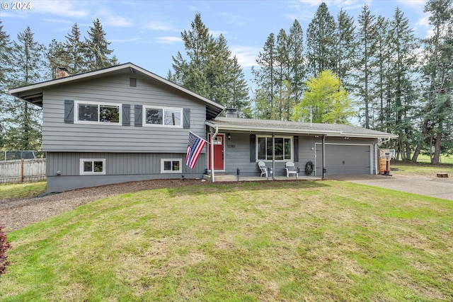 tri-level home featuring a garage and a front yard