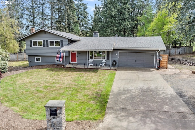 tri-level home with a garage and a front lawn