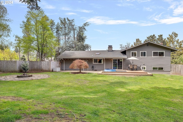 rear view of property with a patio and a yard