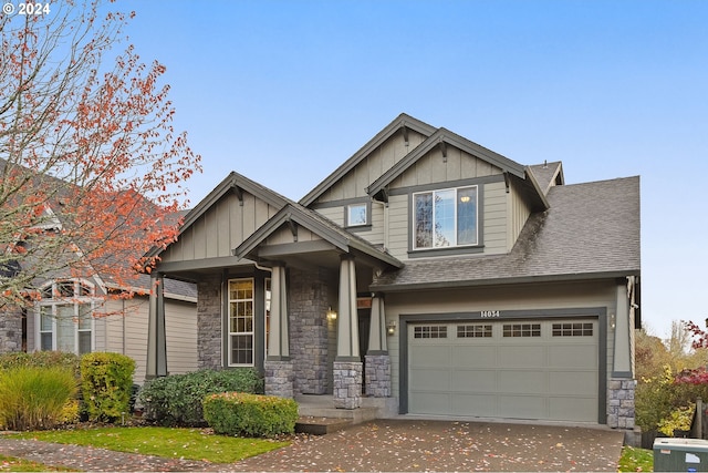 craftsman house featuring a garage and central air condition unit